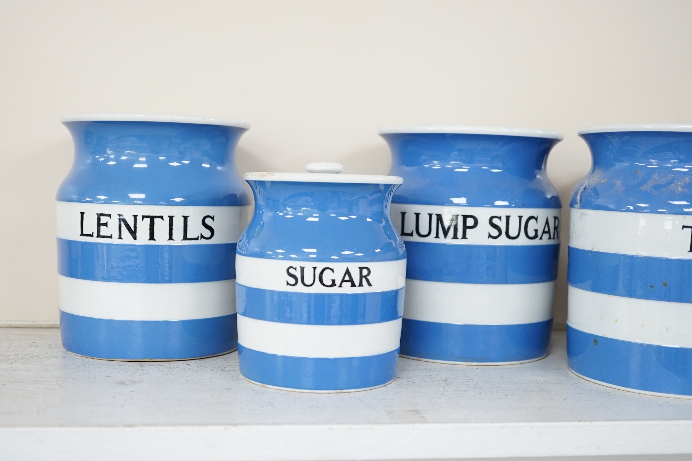 T.G.Green Cornish Kitchenware, nine lidded storage jars and two milk jugs to include Brown Sugar (2), Lump Sugar, Tea, Lentils and Dried Fruit, largest 17.5cm high, mixed marks. Condition - fair to good